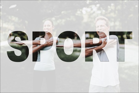 Man and Woman Warm Up Outdoor. Sport in Park. Couple Doing Exercises in Park. Group of People Doing Flexibility Exercises. Guys Leads Healthy Lifestyle. Guys in Light Sportswear. Male Workout at Park.の写真素材