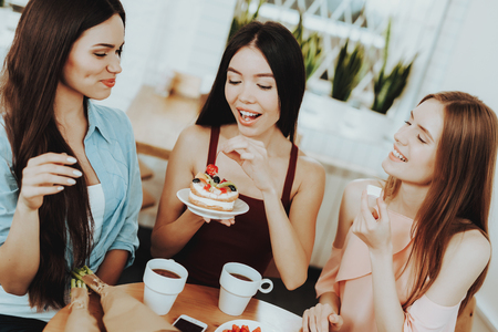 Beautiful Girl and Birthday time with Friends. Good Tea and Good Womens. Gift for Good Girl. Happiness when your Friends Happy. Drinking tea with Cake. Holiday very Funny. Female Good spend Time.の写真素材