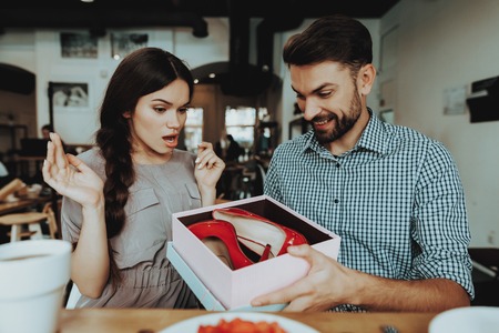 Girl Confuse and Happy. Smile Handsome Man. Springtime People Celebrate 8 March. Holiday and Good Time. Relationship with Handsome Man. Shoes Good Gift for Young Girl. Woman and 8 March Happy Time.の写真素材