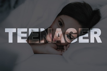 Teenager in Bed. Wonderful Morning. Smiling Girl. Lies in White Bed. Time Go to School. Awakened Girl. Morning Alarm. Student Weekdays. Get Up Early. Little Black-Haired. Child under Blanket.の写真素材