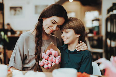 Little Boy and Mother Happy Together. Boy Gift Mother Flowers. Love with Mother and Son. Care Boy with Mom. Romantic Day Boy Happiness and Mother Happy that Boy Gift Flowers. Happy Holiday 8 Marth.の写真素材