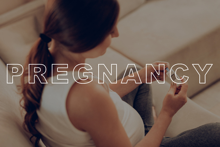 Test Results. Pregnant Woman See Device Screen. Daily Life Expectant Mother. Belly Girl use Sugar Level Analyzer. Woman Anticipation Pregnancy. Preggers Sit at Home. Pregnant Female on Light Sofa.の写真素材