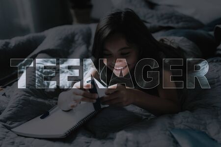 Child Fastens Stapler Sheets. Girl Frowning. Child Listen Music. Student Weekdays. Girl Hold Smartphone and Headphones. Little Black-Haired Girl. Good Morning. Smiling Girl. Teenager in Bed.の写真素材