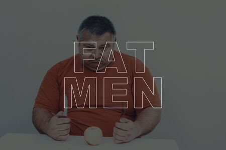 Big Fat Men Overweight Problem. Eat An Apple. Healthy Lifestyle.の写真素材