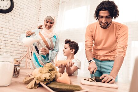 Happy Arabian Family Cooking Food in Kitchen. Muslim Family.の写真素材