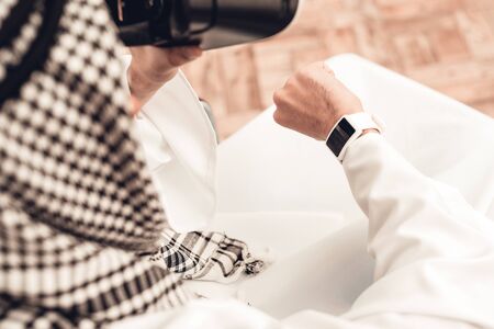 Young Arabian Man on Wheelchair Using VR Glasses. Modern Technology Concept. Sitting on Wheelchair. Disabled Man. Man Using Gadget. Using Digital Device at Home. Sitting Muslim Man.の写真素材