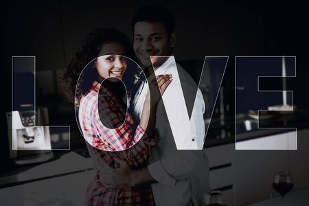 Afro American Couple Is Hanging In Kitchen. Weekend Concept. Holiday Resting. Smiling Together. Having Fun. Romantic Date. Cheerful Sweethearts. Staring At Each Other. Happy Family.の写真素材