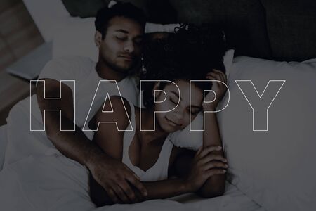 Afro American Couple Are Sleeping In The Bed. Resting Together. Hanging Each Other. Hoiday Leisure. Heads On Pillows. Eyes Closed. Morning Dreaming. Weekend Relaxing. Family Harmony.の写真素材