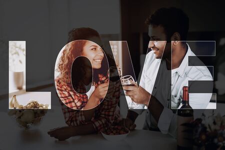 Afro American Couple Drinking Wine On In Kitchen. Weekend Concept. Family Holiday Resting. Romantic Date.の写真素材