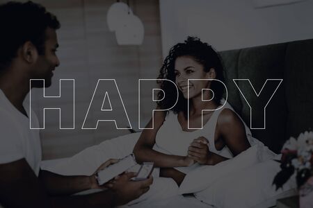Happy Couple. Holiday Date. Man Showing a Present to Her Girlfriend.の写真素材
