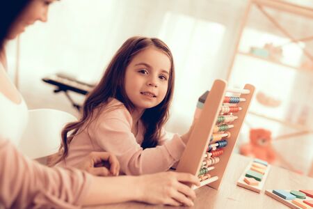 Woman Teaches Girl. Educational Games. Learning Child at Home. Cubes and Puzzles. Child Development. Board Games for Children.の写真素材