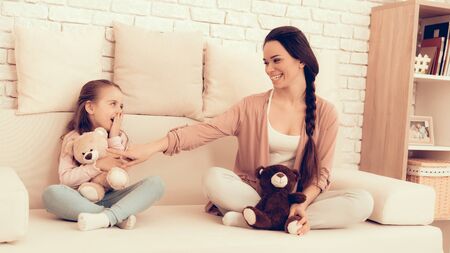 Mother Have Fun with Daughter. Kids Home Games. Rest at Home. Child Development. Mom and Daughter Play. Happy Mom and Child in Pajamas. White Sofa.の写真素材