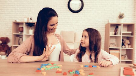 Woman Teaches Girl. Educational Games. Learning Child at Home. Child Development. Board Games for Children. Modern Learning for Children.の写真素材