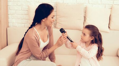 Mother Have Fun with Daughter. Kids Home Games. Learning at Home. Child Development. Mom and Daughter Sing. Singing with Microphone.の写真素材
