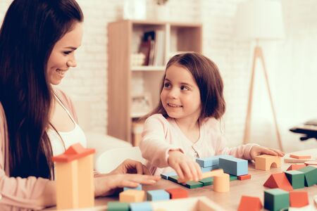 Mother Teaches Daughter. Educational Games. Learning Child at Home. Build House of Cubes. Child Development. Board Games for Children. Modern Learning for Children.の写真素材