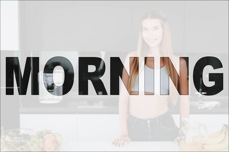 Happy Morning. Girl Posing in the Kitchen. Girl Standing near the Table. Food on Table. Food is Vegetables and Fruits. Girl Have a Healthy Lifestyle.の写真素材