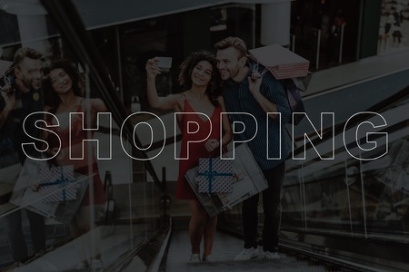 Young Couple Do Selfie On Escalator. Black Friday Sale. Holiday Discounts.