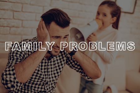 Kid Shouts In The Megaphone Into Father's Ears. Problems Concept.