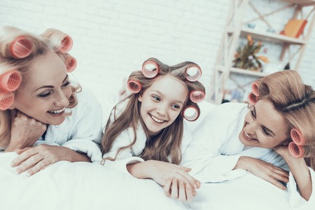 Smiling Women in White Bathrobes Have Fun at Home.の写真素材