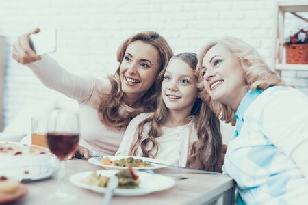 Happy Family Celebrating and Taking Selfie at Home. Cake on Table. Happy Family. Mother with...