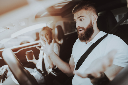 Man Behind The Wheel Of Car. Girl At Front Seat. Innovation Technology. New Generation Electro Hybrid Vehicle. Luxury Design. Futuristic Power. Fasten Seatbells. Test Driving.の写真素材