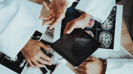 Close Up of Doctors Hands Holding Mobile Device. Doctor Using Tablet. Examination. Medical Concept. Medical Equipment Concept. Top View. Discussing Diagnosis. Examination. Medical Concept.の写真素材