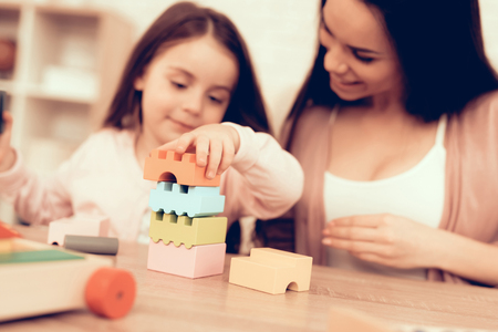 Mother Teaches Daughter. Educational Games. Learning Child at Home. Cost House of Cubes. Cubes and Puzzles. Child Development. Board Games for Children. Modern Learning for Children. Play Cubes.の写真素材