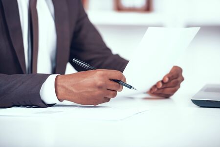Cropped African Businessman Holding Document.の写真素材