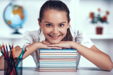 Kid is Leaned to Books Stack at Primary School.の写真素材