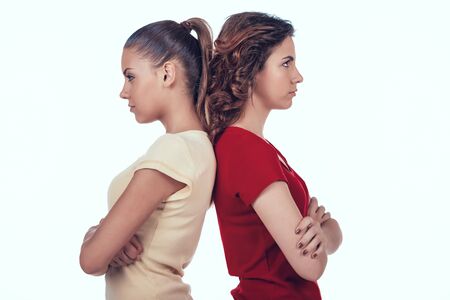 Jealous Women Standing with Backs to Each Other.の写真素材