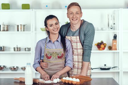 Happy Couple Making Domestic Pastry at Kitchen.