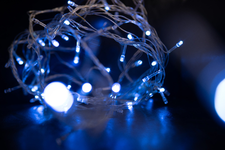 Abstract background. Blurred blue garland on defocused background.