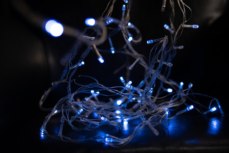 Abstract background. Blurred blue garland on defocused background.の写真素材
