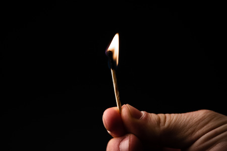 Burning matches close-up image. Matches flame macro image on dark background.の写真素材
