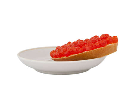 Bread with red caviar on plate on white backgroundの写真素材