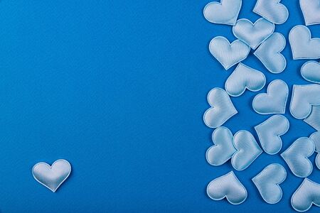 A lot of blue little hearts on a blue backgroundの写真素材