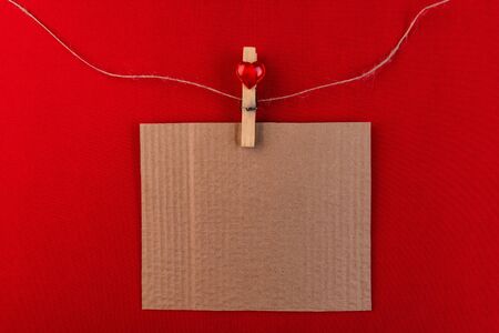 Cardboard plate on a red background. Valentine's Day