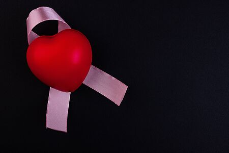 Pink ribbon breast cancer awareness symbolic bow color raising support on people living with women's...