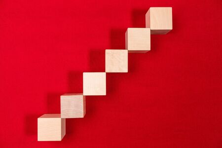 Wooden toy cubes isolated on a red