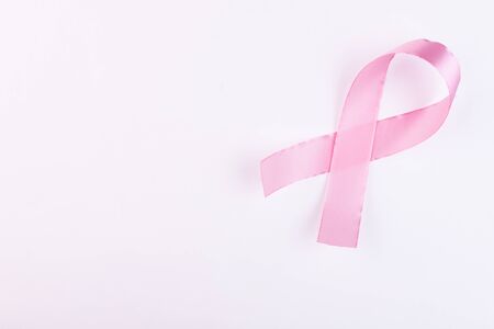 Pink ribbon breast cancer awareness symbolic bow color raising support on people living with women's breast tumor illnessの写真素材
