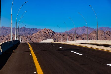 Empty desert road in Egypt with clear blue skyの写真素材