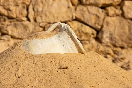 A clay jug buried in the sandの写真素材