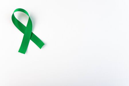 Kelly Green Ribbon a Symbol of Kidney Cancer with copy spaceの写真素材