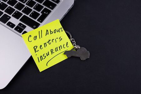 Insurance for renters and tenants Call about renters insurance words written on notepad sticky note on computer keyboard conceptual insurance policy coverage reminder and promotional photographyの写真素材