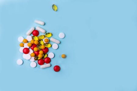 many scattered Colorful pills on a blue backgroundの写真素材