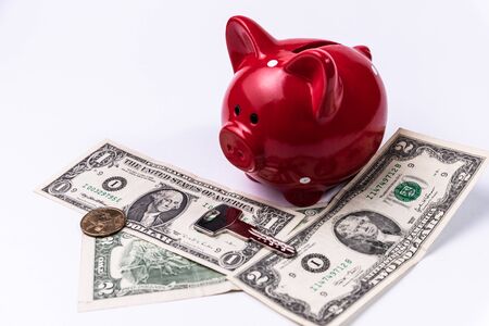 Piggy Bank on with dollar bills and keysの写真素材