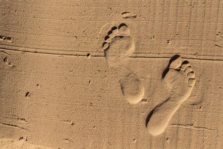 Two Footprints in sand at the Beachの写真素材