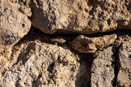 Old and weathered large stone blocks wall texture