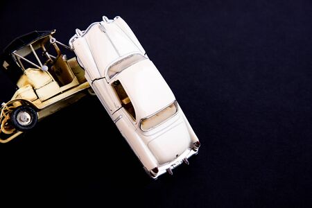 Close-up of two toy cars accident on a black backgroundの写真素材