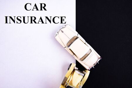 Close-up of two toy car accident and inscription CAR INSURANCEの写真素材